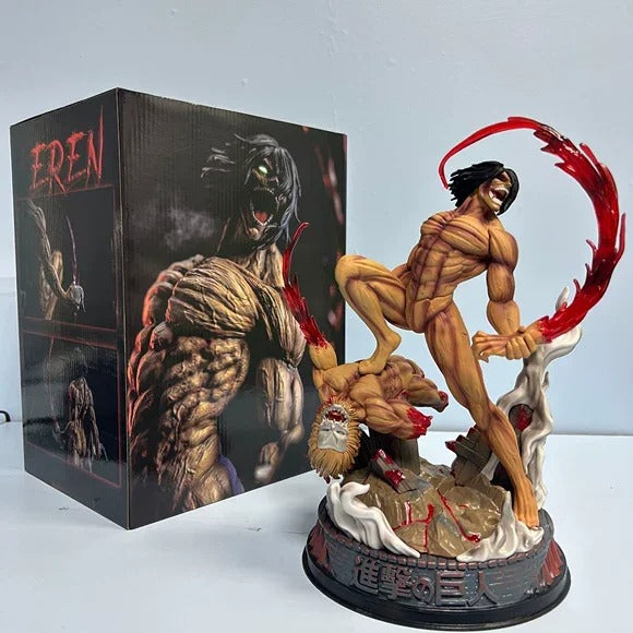 Action figure of a muscular character with a red weapon next to its packaging Attack on Titan: Eren Yeager (Attack Titan Form) - The Defeat of the Jaw Titan 29cm Premium Diorama Statue