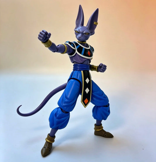 Action figure of a character with blue outfit and purple accents on a gradient background Bandai S.H.Figuarts Dragon Ball Super: God of Destruction Beerus Authentic Premium Action Figure