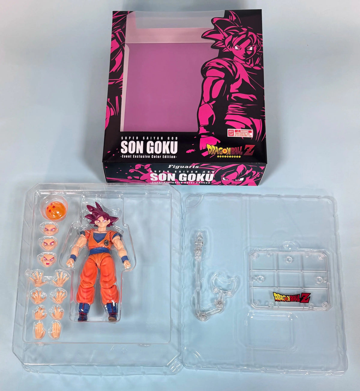 Action figure of Son Goku from Dragon Ball Z with packaging on a light gray background Bandai S.H.Figuarts Dragon Ball Super: Super Saiyan God Son Goku Authentic Premium Action Figure