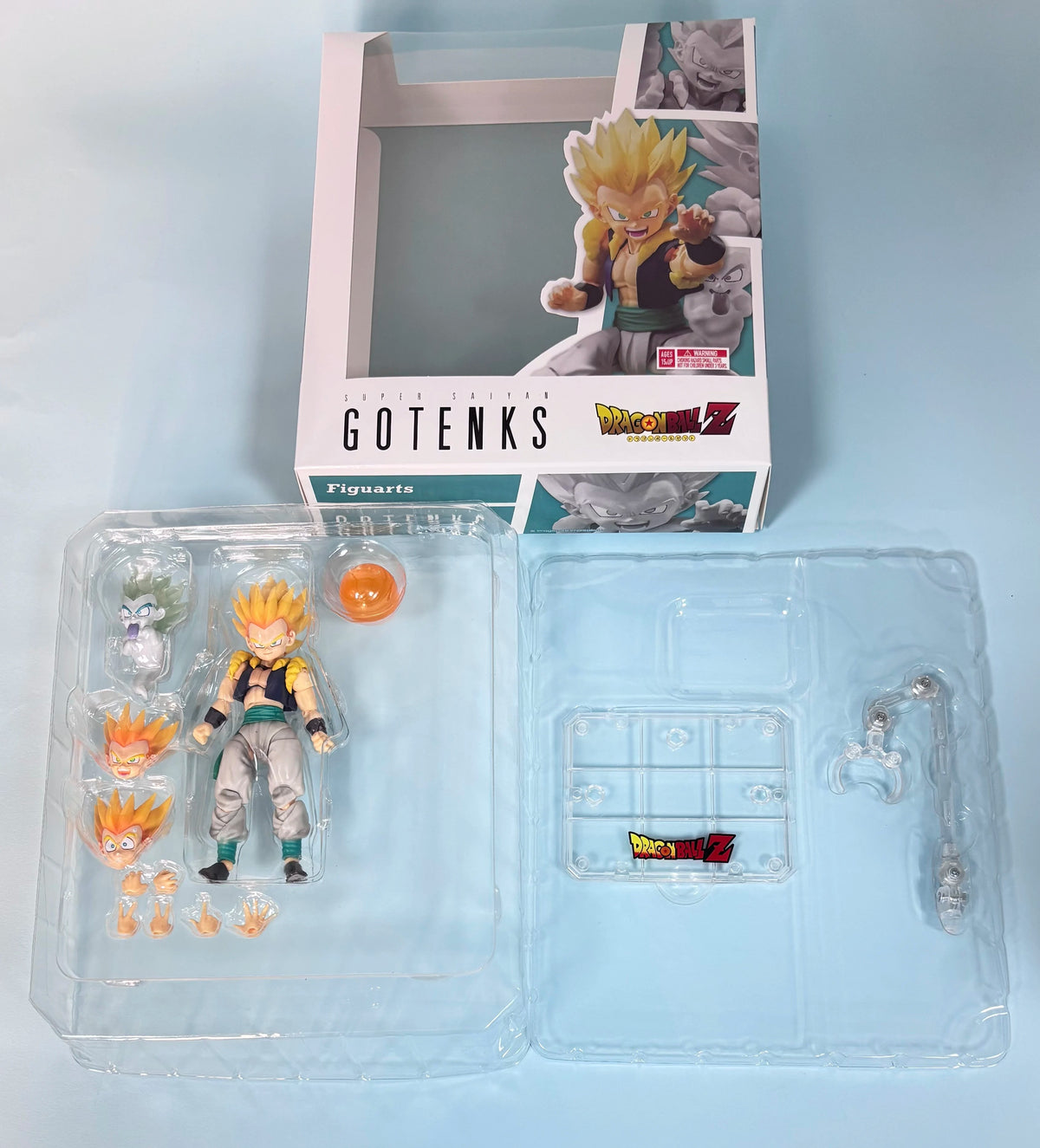 Action figure packaging with character illustration and Gotenks branding on a light blue background Bandai S.H.Figuarts Dragon Ball Z/Super: Super Saiyan Gotenks Authentic Premium Action Figure