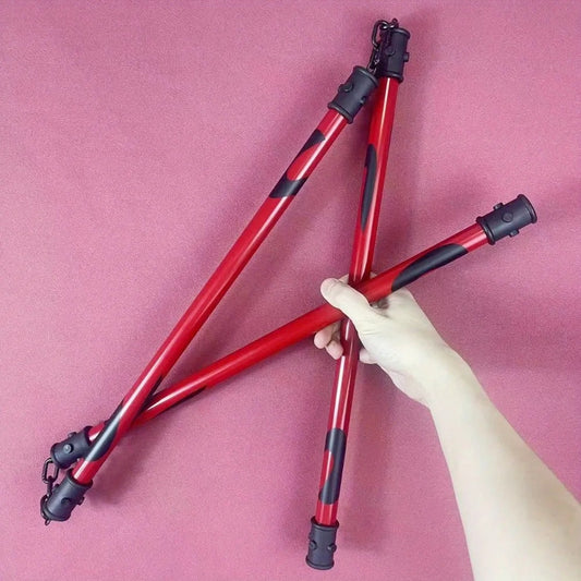 Red and black adjustable tripod legs held by a hand against a pink background Jujutsu Kaisen Maki Zenin Authentic 19.7-Inch Sansetsukon Three-Section Staff Cosplay Prop – Special Grade Cursed Tool Playful Cloud Edition