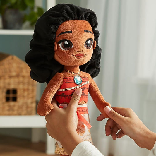 Plush doll with a person holding it, set against a blurred indoor background Official Disney Moana Wayfinder Princess – 14-Inch Premium Cotton Plush by Titantoons