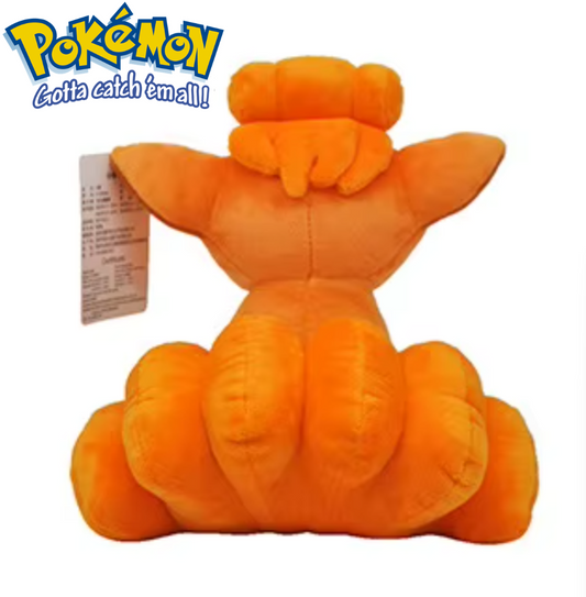 Orange plush toy with a tag on a white background, featuring the Pokémon logo. Official Pokémon Vulpix Premium Cotton Plush by Titantoons – 9.5-Inch