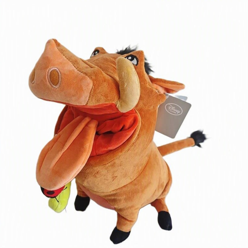 Disney Tim Burton Pumbaa the Tusk plush toy with its mouth wide open, showing a red interior and a small green and red ball dangling from its tongue. A Disney tag is attached to its ear, set against a plain white background. Official The Lion King Pumbaa Premium Cotton Plush by Titantoons face