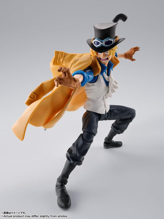 Action figure with a yellow coat and black hat on a gray background One Piece: Sabo (Revolutionary Army Chief of Staff Ver.) Authentic S.H. Figuarts Fully Articulated Action Figure by Bandai Spirits