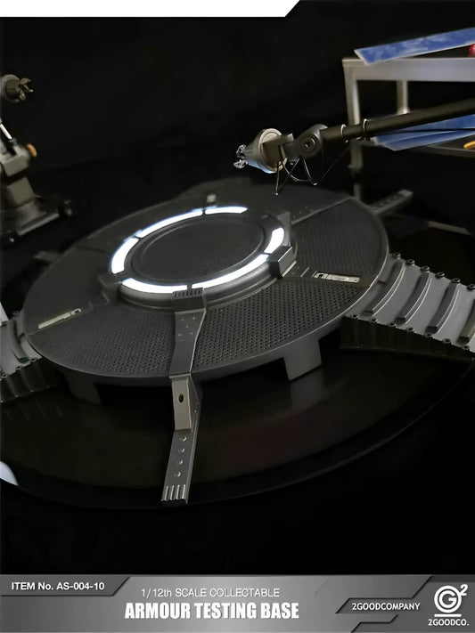 Model of an armour testing base with glowing elements on a dark background, featuring the brand '2GoodCompany'. 2GOODCO 1/12 Scale LED Light Armor Testing Base Workshop Mechanical Diorama Set