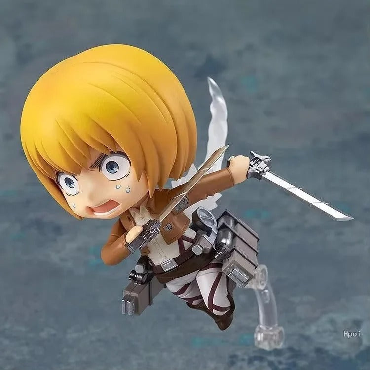 Action figure with yellow hair and sword on a gray background Attack on Titan: Armin Arlert (Q-Clay Series) Fully Articulated Action Figure with Interchangeable Faceplates