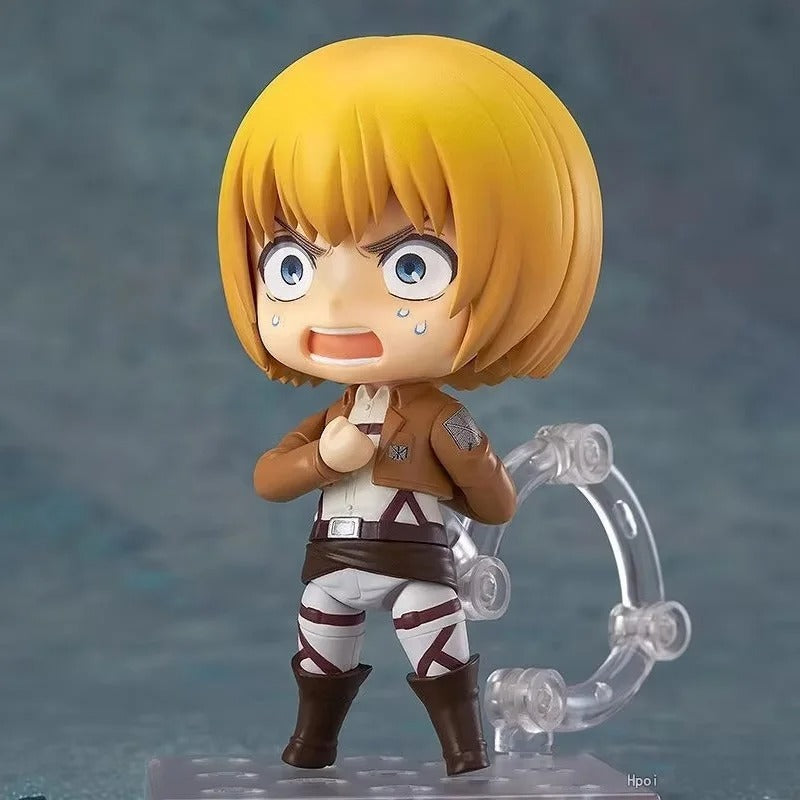 Small figurine with blonde hair and a determined expression on a gray background Attack on Titan: Armin Arlert (Q-Clay Series) Fully Articulated Action Figure with Interchangeable Faceplates