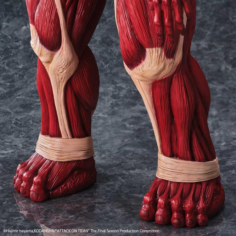 Close-up of red muscular legs with visible tendons on a dark gray background Attack on Titan: Bertholdt Hoover - The Colossal Titan Mega Sofvi Advance MS021 Premium Vinyl Figure by Kaiyodo