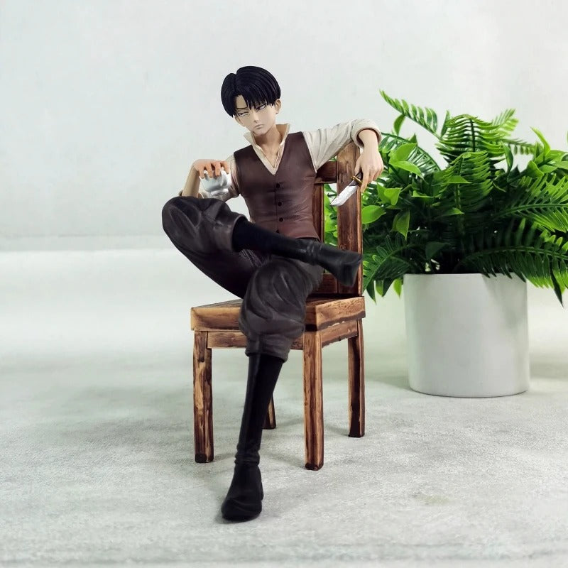 Person sitting on a chair with a plant in the background Attack on Titan: Captain Levi Ackerman (Side Story Series No.1 - Tea Time) 19cm Premium Resin Statue by TITAN Studio