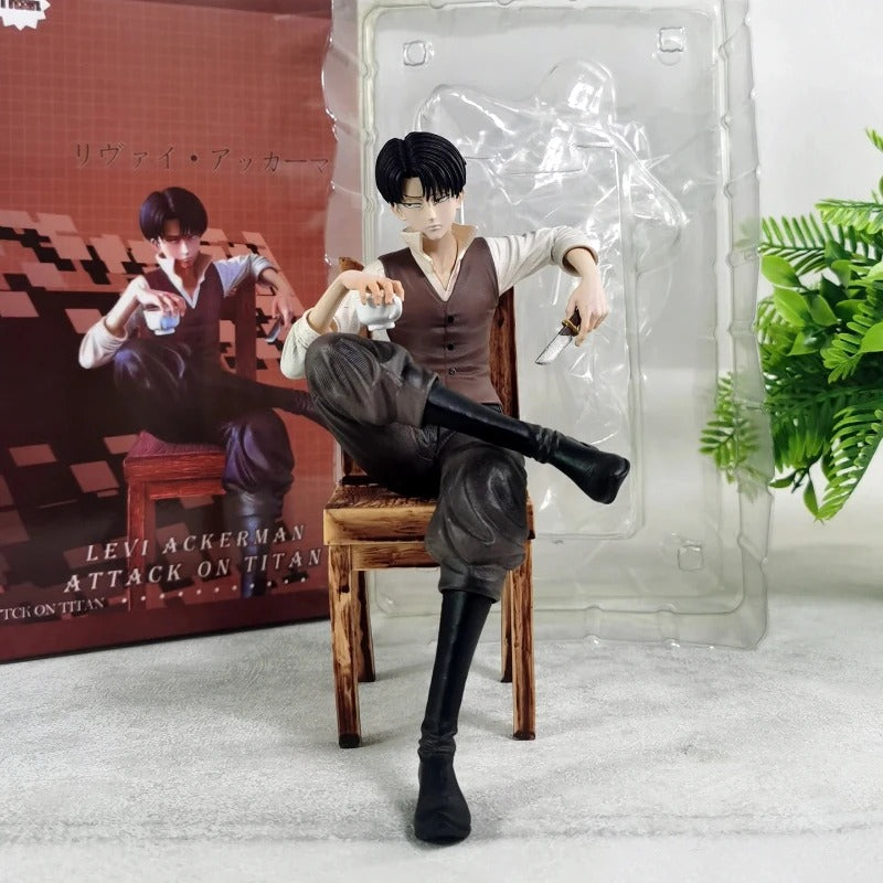 Figure of a character from 'Attack on Titan' sitting on a chair with packaging in the background. Attack on Titan: Captain Levi Ackerman (Side Story Series No.1 - Tea Time) 19cm Premium Resin Statue by TITAN Studio