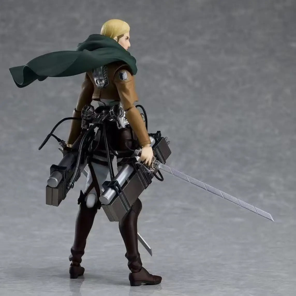 Action figure with a sword and mechanical components on a gray background Attack on Titan: Commander Erwin Smith (Figma No.446) Highly Poseable Premium Action Figure by Max Factory