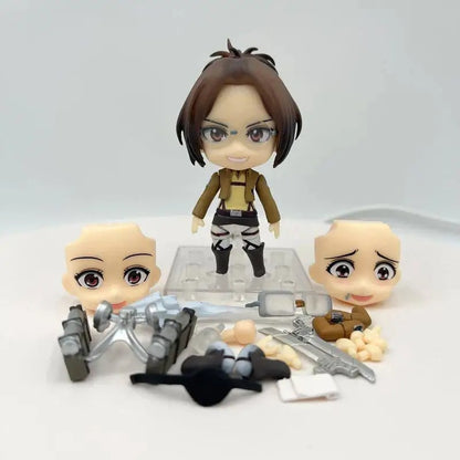 Set of small figurines with a central character holding a weapon on a white background Attack on Titan: Hange Zoë (Nendoroid No.1123) Authentic Fully Articulated Premium Chibi Figure by Good Smile Company