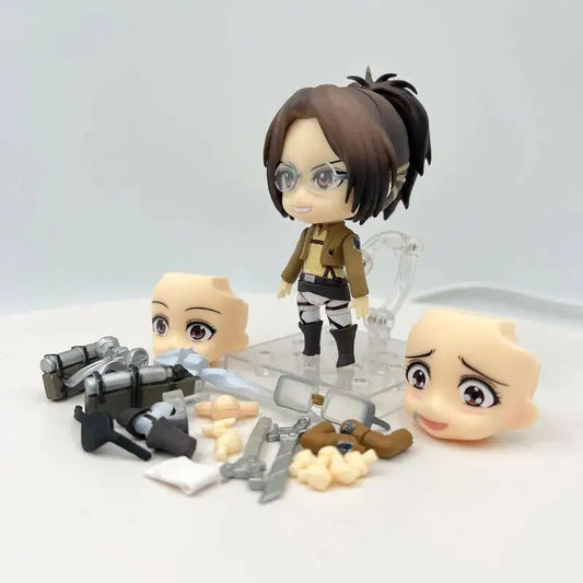 Small figurines with interchangeable parts on a white background Attack on Titan: Hange Zoë (Nendoroid No.1123) Authentic Fully Articulated Premium Chibi Figure by Good Smile Company
