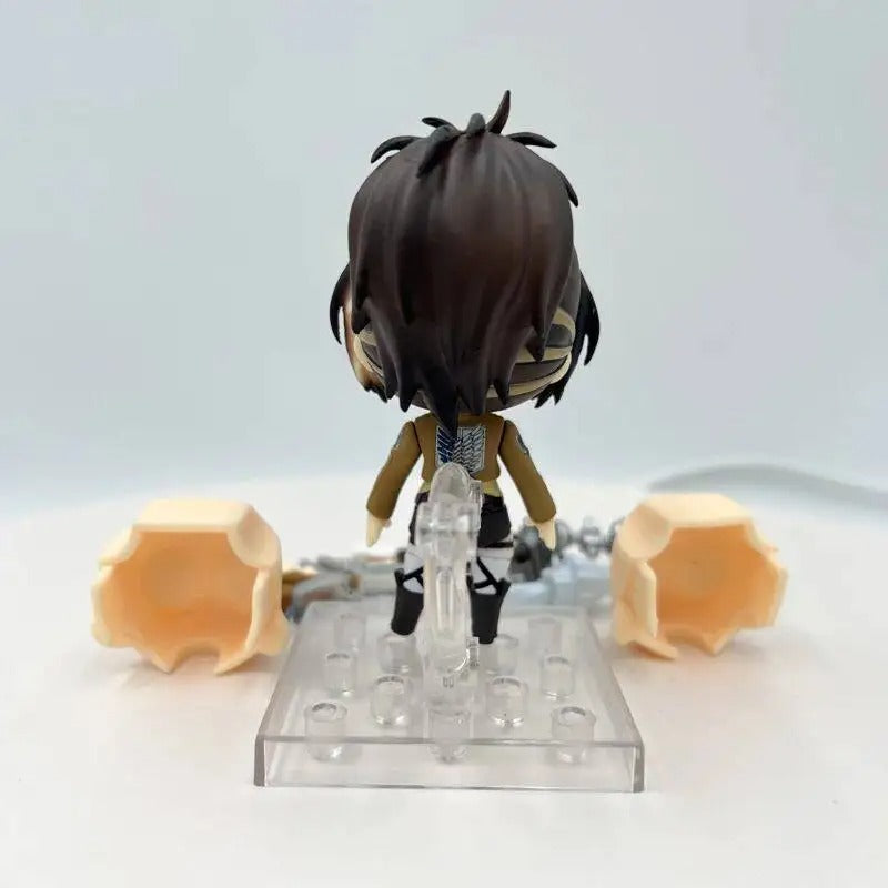 Small figurine on a clear stand with two orange objects on a white background Attack on Titan: Hange Zoë (Nendoroid No.1123) Authentic Fully Articulated Premium Chibi Figure by Good Smile Company