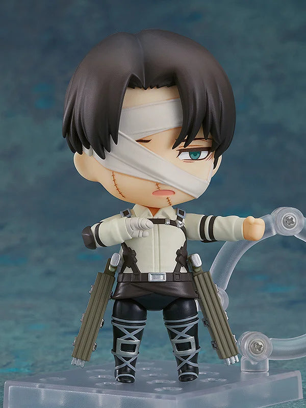 Action figure with bandaged face and weapons on a blue gradient background Attack on Titan: Levi Ackerman (The Final Season - Nendoroid No.2002) Authentic Fully Articulated Chibi Figure by Good Smile Company