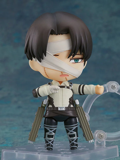 Action figure with bandaged face and weapons on a blue gradient background Attack on Titan: Levi Ackerman (The Final Season - Nendoroid No.2002) Authentic Fully Articulated Chibi Figure by Good Smile Company