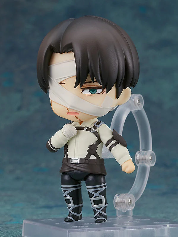 Nendoroid figurine with bandages on face and arms, standing on a clear stand against a blue gradient background. Attack on Titan: Levi Ackerman (The Final Season - Nendoroid No.2002) Authentic Fully Articulated Chibi Figure by Good Smile Company
