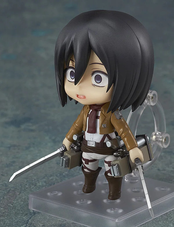Action figure of a character with dark hair and a brown outfit on a clear stand. Attack on Titan: Mikasa Ackerman (Nendoroid No.365) Authentic Fully Articulated Premium Chibi Figure by Good Smile Company