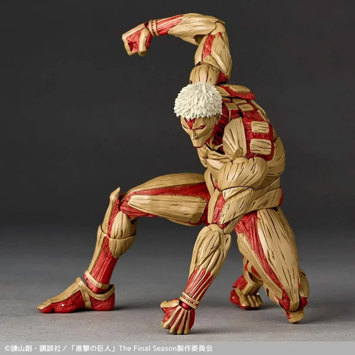 Action figure of a character from 'Attack on Titan' with red and beige details on a gray background Attack on Titan: Reiner Braun - The Armored Titan Amazing Yamaguchi No.042 Revoltech Action Figure by Kaiyodo