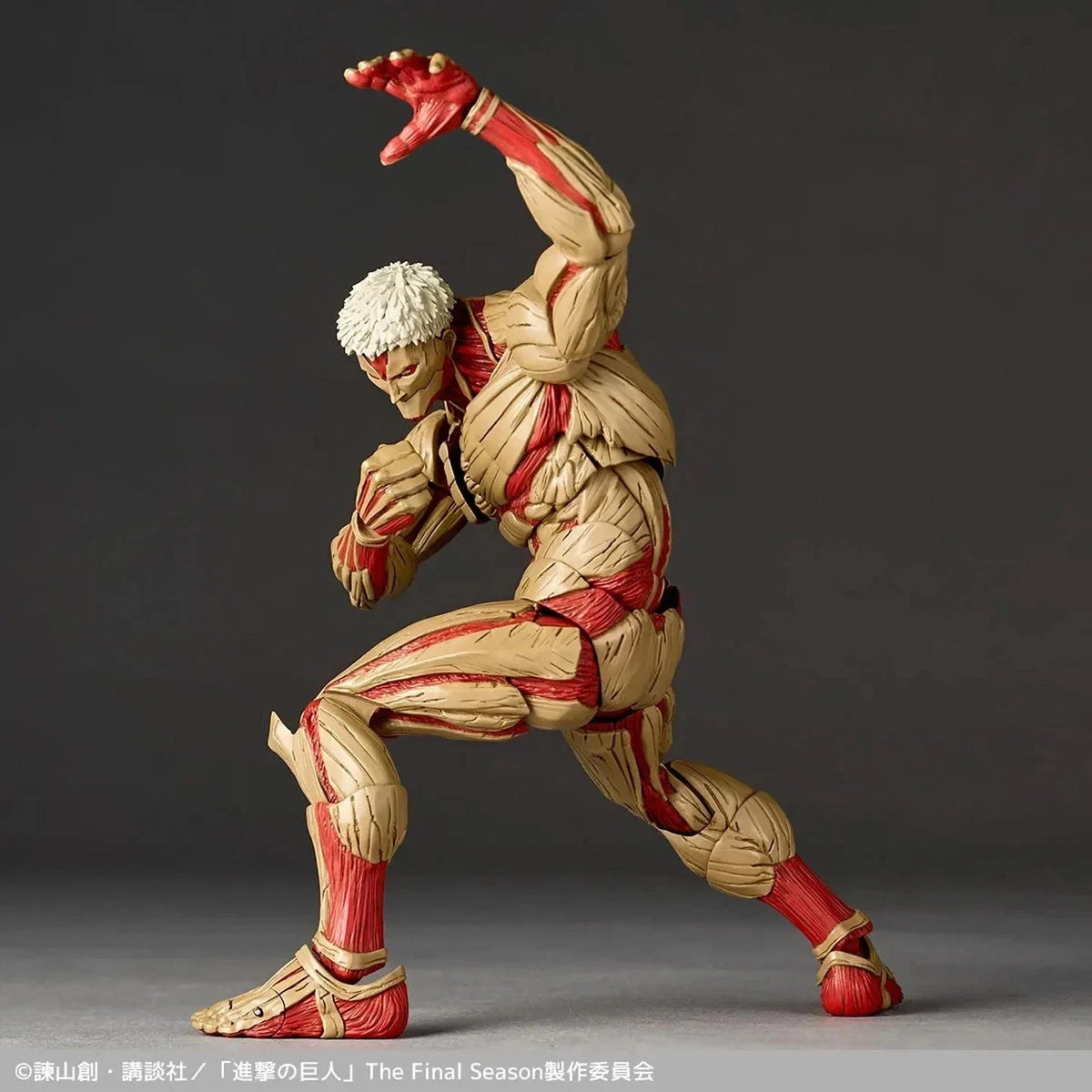 Action figure in dynamic pose with red and beige costume on a dark background Attack on Titan: Reiner Braun - The Armored Titan Amazing Yamaguchi No.042 Revoltech Action Figure by Kaiyodo