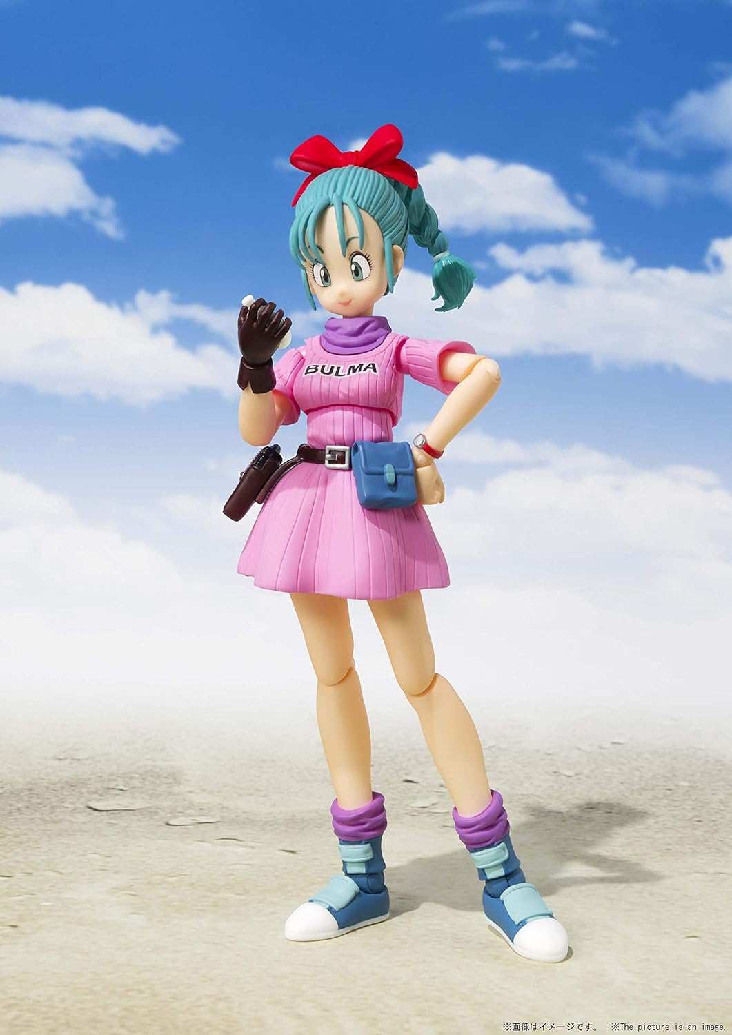 Action figure of Bulma from Dragon Ball Z on a beach with blue sky and clouds in the background Bandai S.H.Figuarts Dragon Ball: Bulma -Adventure Begins- Authentic Premium Action Figure 3