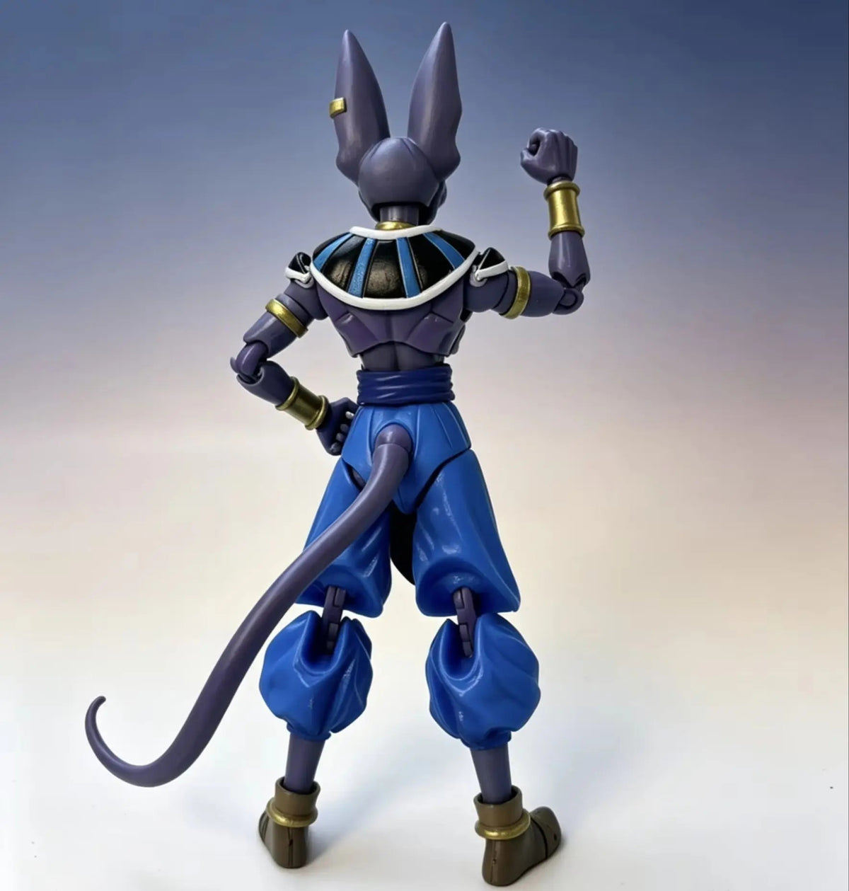 Action figure with blue and gray costume on a gradient background Bandai S.H.Figuarts Dragon Ball Super: God of Destruction Beerus Authentic Premium Action Figure