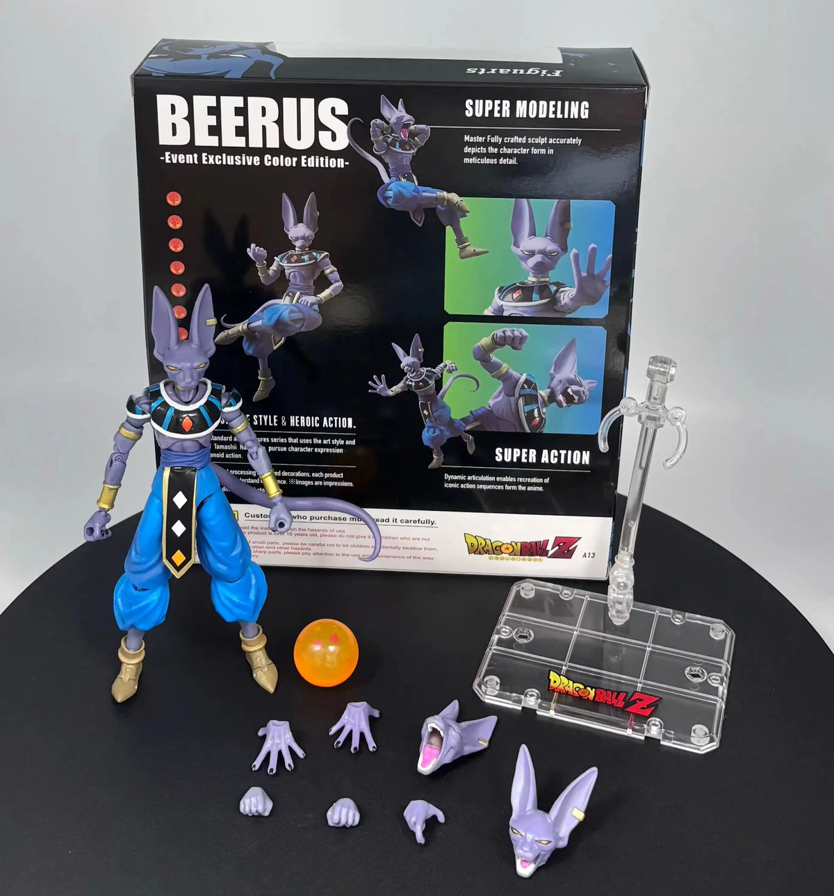 Beerus action figure with accessories and packaging on a black surfacevBandai S.H.Figuarts Dragon Ball Super: God of Destruction Beerus Authentic Premium Action Figure