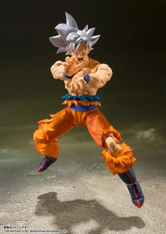 Action figure in dynamic pose on a textured surface with a dark background Bandai S.H.Figuarts Dragon Ball Super: Son Goku (Ultra Instinct) Authentic Premium Action Figure