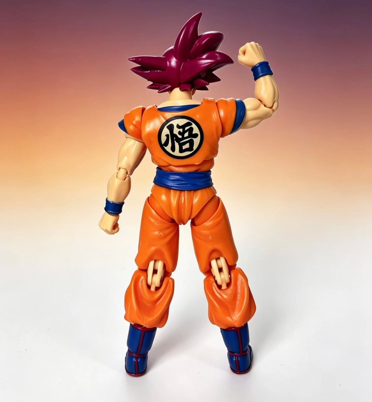 Action figure in orange and blue outfit with a symbol on a gradient background Bandai S.H.Figuarts Dragon Ball Super: Super Saiyan God Son Goku Authentic Premium Action Figure