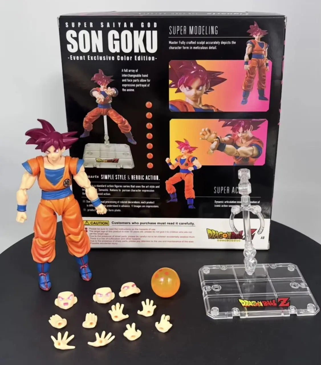 Action figure of Son Goku from Dragon Ball Z with packaging and accessories on a black surface. Bandai S.H.Figuarts Dragon Ball Super: Super Saiyan God Son Goku Authentic Premium Action Figure 