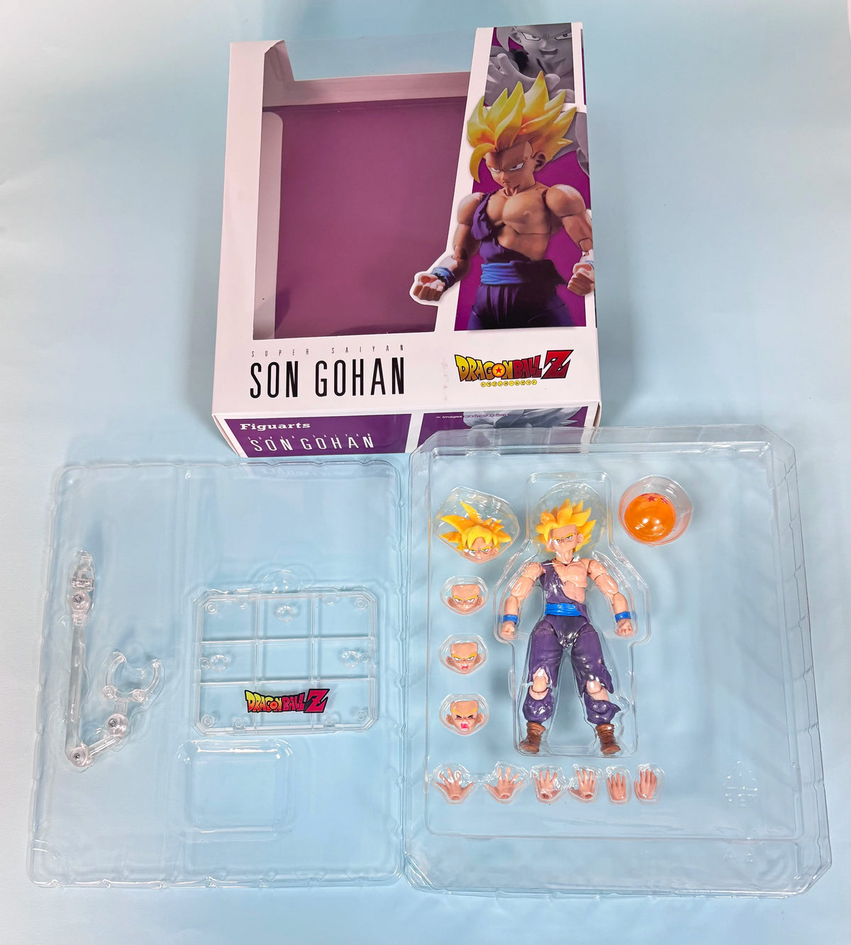 Action figure of Son Gohan from Dragon Ball Z in packaging with accessories. Bandai S.H.Figuarts Dragon Ball Z: Super Saiyan Gohan Authentic Premium Action Figure
