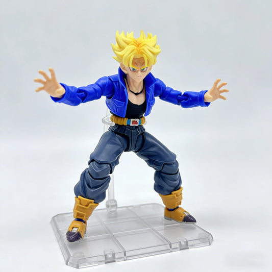 Action figure of a character in blue and yellow outfit on a clear base with a white background Bandai S.H.Figuarts Dragon Ball Z: Super Saiyan Trunks Authentic Premium Action Figure
