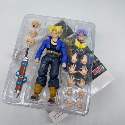 Action figure in packaging with interchangeable parts on a white background Bandai S.H.Figuarts Dragon Ball Z: Super Saiyan Trunks Authentic Premium Action Figure