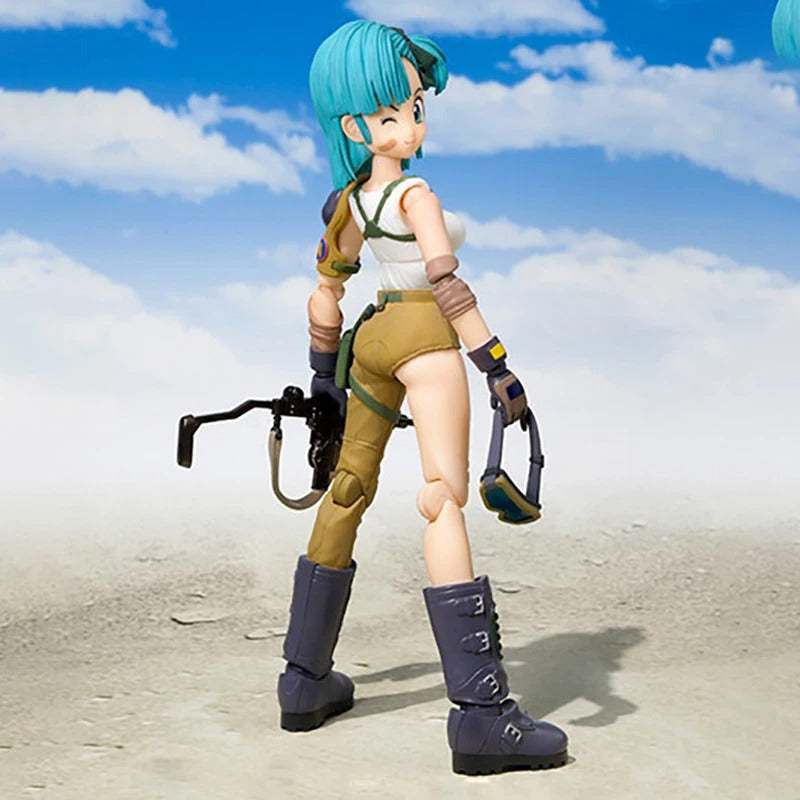 Action figure with green hair and a white outfit standing on a sandy surface with a blue sky. Bandai S.H.Figuarts Original Dragon Ball: Bulma Authentic Premium Action Figure 