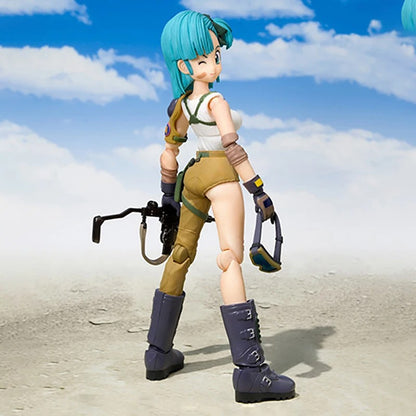Action figure with green hair and a white outfit standing on a sandy surface with a blue sky. Bandai S.H.Figuarts Original Dragon Ball: Bulma Authentic Premium Action Figure 