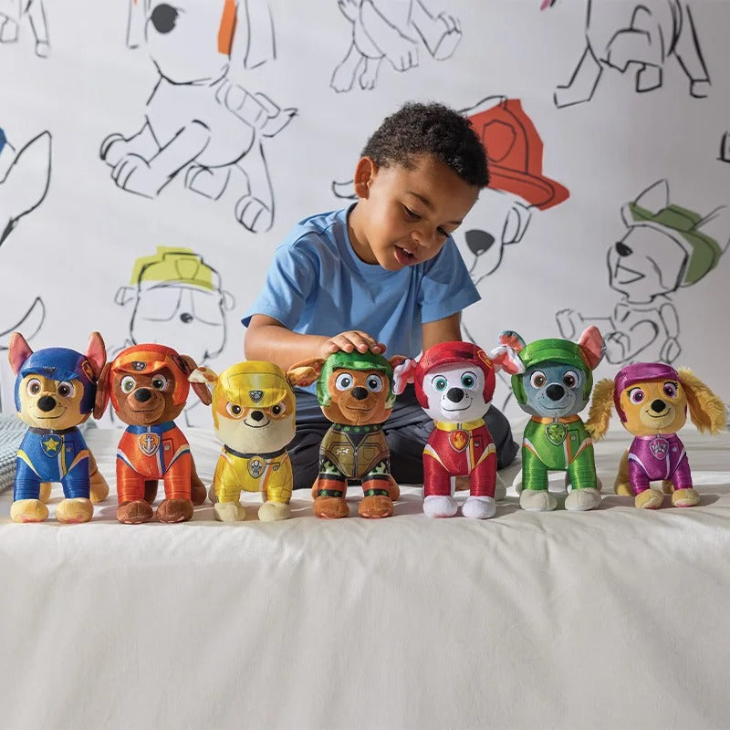 Child playing with Paw Patrol toy figures against a wall with drawings of characters. Brave Rubble Official Rescue Mission Edition – 7.3-Inch Premium Cotton Plush by Titantoons