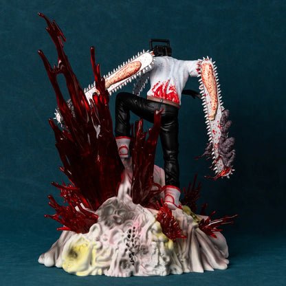 Gore-themed figurine with a person holding a chainsaw amidst red and white elements on a dark background. Chainsaw Man Denji 29cm Battle Scene Authentic Diorama Figure – Premium Visceral Gore & Translucent Blood Splatter Extra-Large Collectible Character Statue