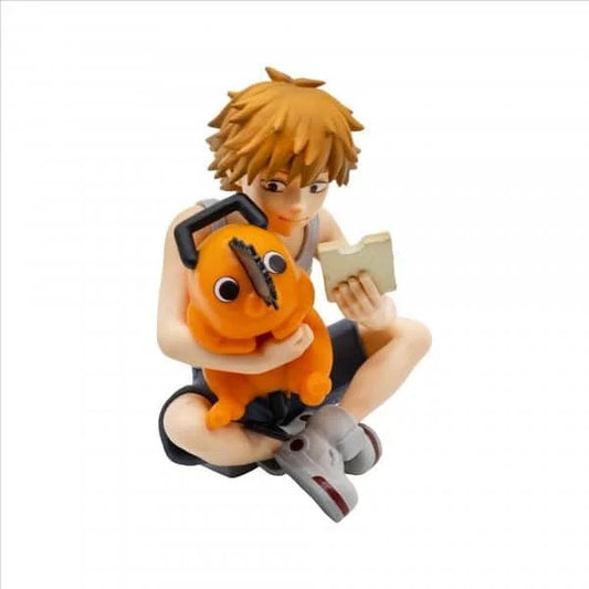 Figurine of a character with orange hair holding a book and an orange creature on a white background. Chainsaw Man Denji & Pochita Authentic Break Time Collection Vol.3 Fixed-Pose Interaction Statue by Bandai Banpresto