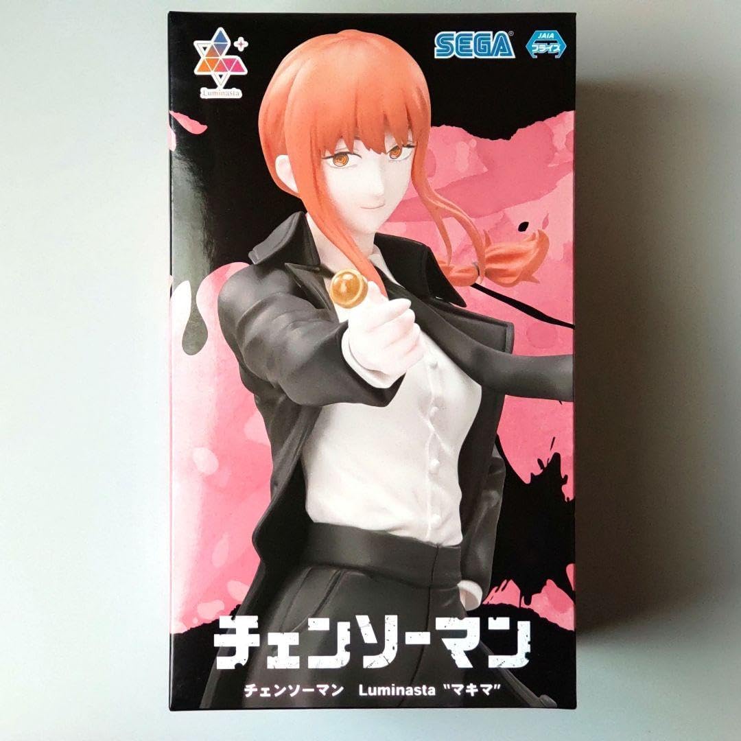 Boxed figure of an animated character with orange hair and a black jacket, featuring Sega branding. Chainsaw Man Makima Authentic 22cm Luminasta Figure – Iconic Lollipop Pose Public Safety Control Devil Statue by SEGA box