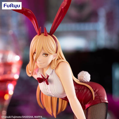 Anime character figurine with bunny ears and red outfit on a blurred background. Chainsaw Man Power Authentic 25cm BiCute Bunnies Figure – Real Fabric Fishnet Tuxedo Costume Statue by FuRyu face