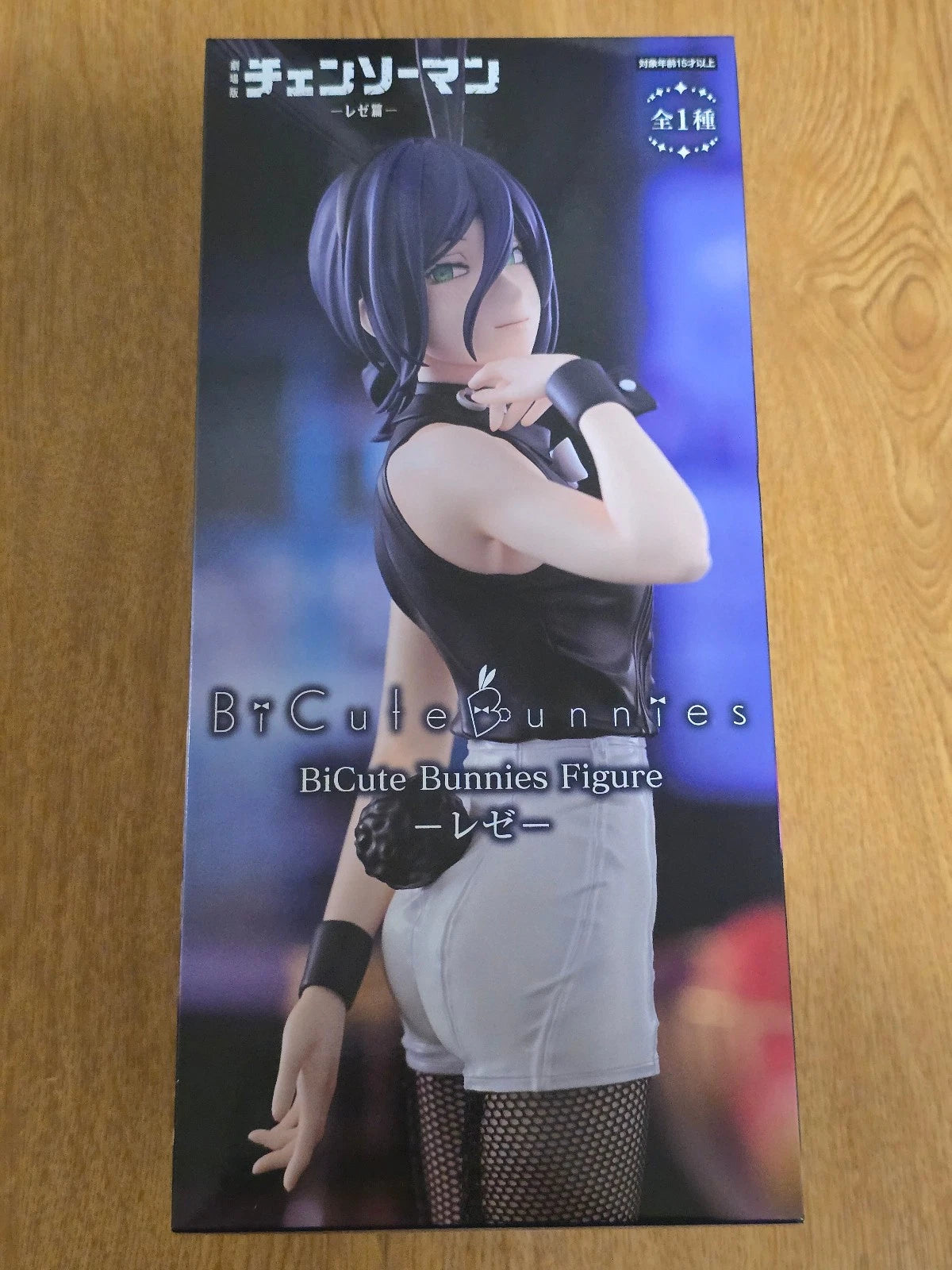 Product packaging for a figure with an anime-style character on a wooden surface Chainsaw Man Reze Authentic 27cm BiCute Bunnies Figure – Real Fabric Fishnet Tuxedo Costume Movie Statue by FuRyu box