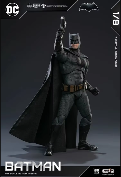 Batman action figure with cape and mask, holding a gun, on a dark background with DC Comics branding. DC Comics Batman (Tactical/Justice League Edition) 1/9 Scale Premium Action Figure by FondJoy