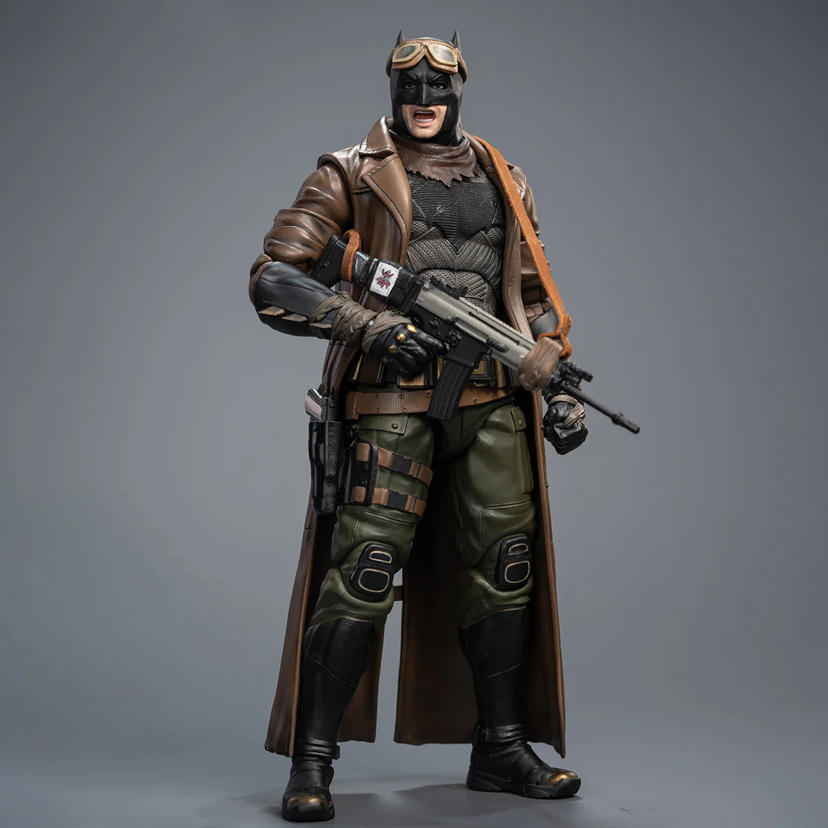Action figure in a detailed costume with a gun on a gray background DC Comics Knightmare Desert Batman (Batman v Superman Edition) 1/9 Scale Premium Action Figure by FondJoy