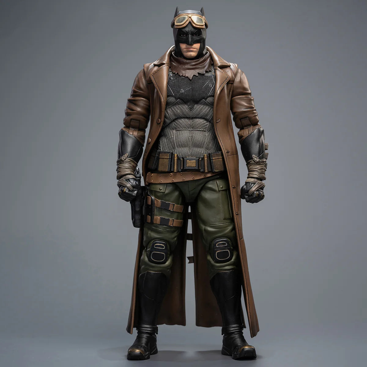 Superhero figure in a detailed costume with a coat and helmet on a gray background DC Comics Knightmare Desert Batman (Batman v Superman Edition) 1/9 Scale Premium Action Figure by FondJoy 