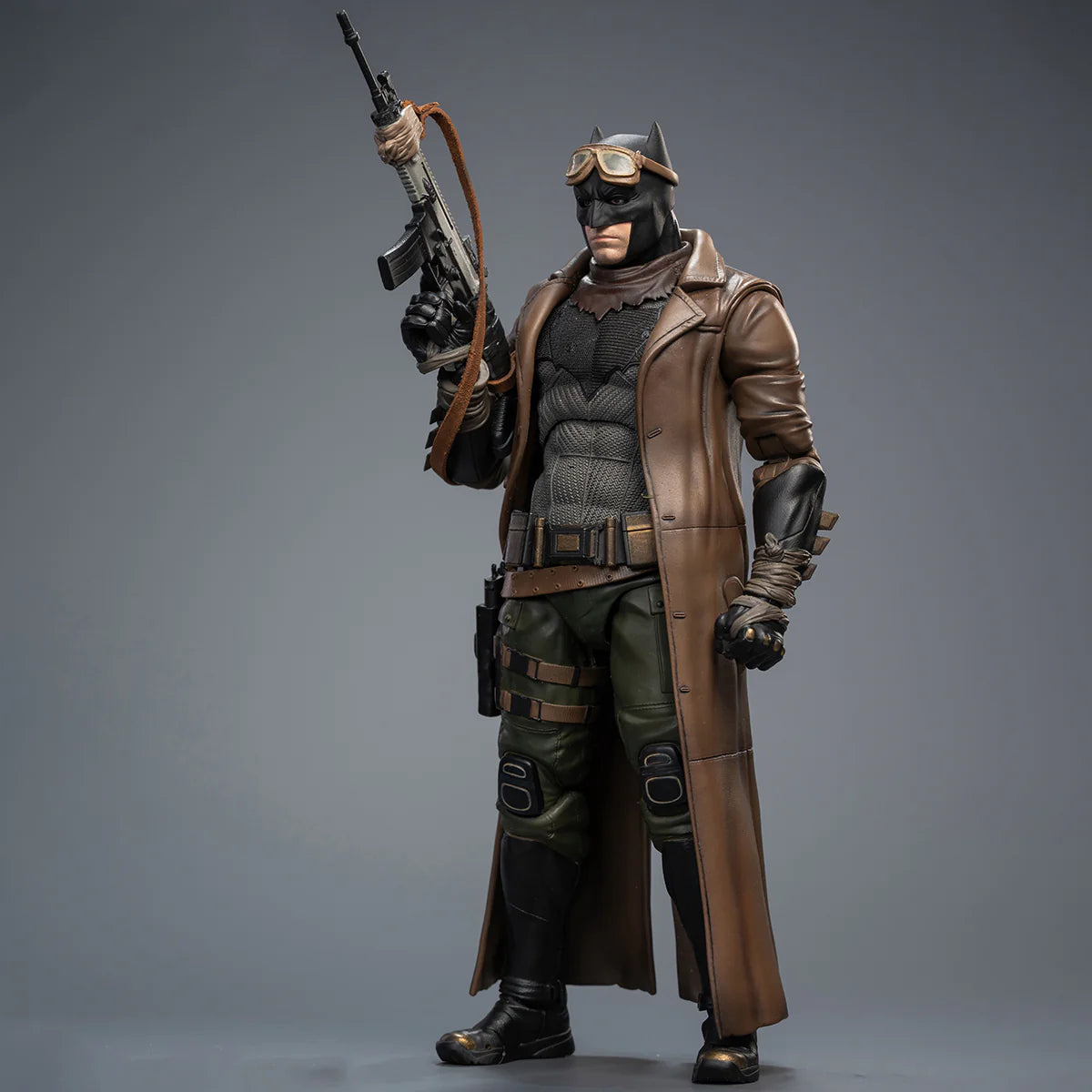 Action figure in a detailed costume with a weapon on a gray background DC Comics Knightmare Desert Batman (Batman v Superman Edition) 1/9 Scale Premium Action Figure by FondJoy
