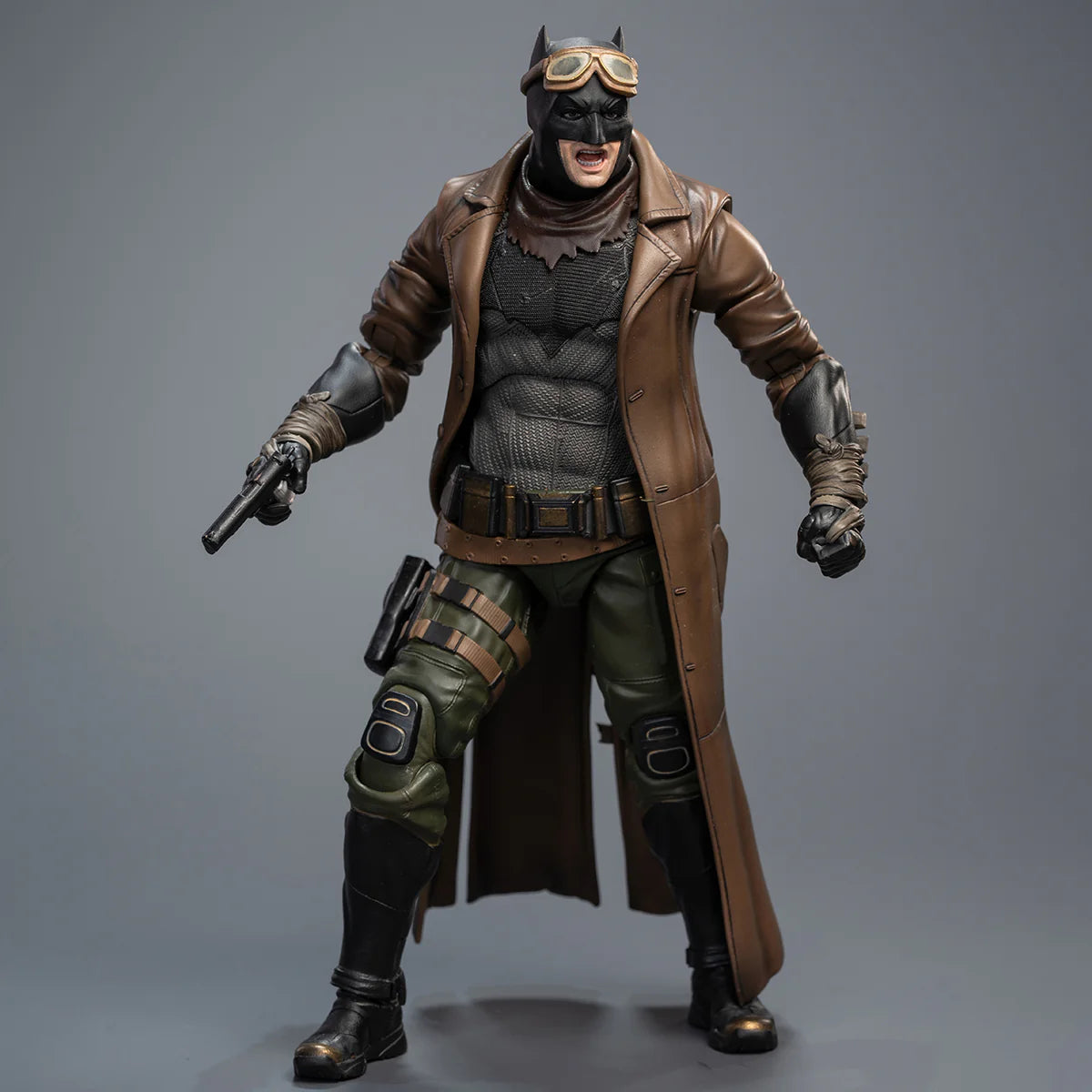 Action figure in a detailed costume with a brown coat and green pants on a gray background DC Comics Knightmare Desert Batman (Batman v Superman Edition) 1/9 Scale Premium Action Figure by FondJoy