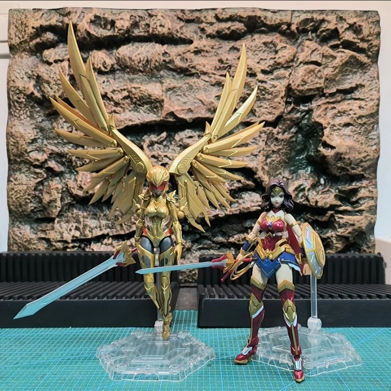 Two action figures, one gold and one multicolored, standing on a grid surface with a rocky background. DC Comics Wonder Woman (DC-01) 1/10 Scale Mecha-Girl Model Kit by MS General