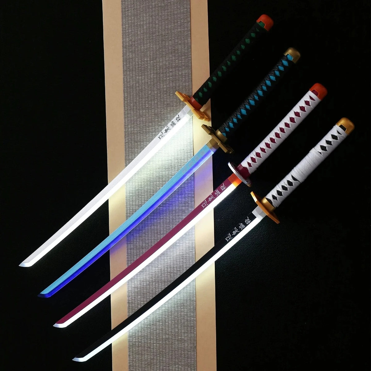 Four colorful swords with LED lights on a dark background Demon Slayer 40-Inch Illuminated LED Bamboo Nichirin Katana Prop Replicas – Next-Gen USB-C Rechargeable Touch-Activated Cosplay & Display Series