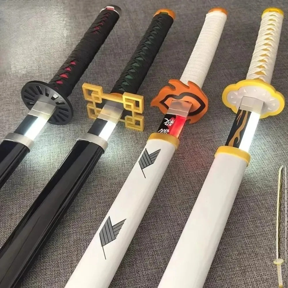 Four sword handles with different designs on a textured surface Demon Slayer 40-Inch Illuminated LED Bamboo Nichirin Katana Prop Replicas – Next-Gen USB-C Rechargeable Touch-Activated Cosplay & Display Series